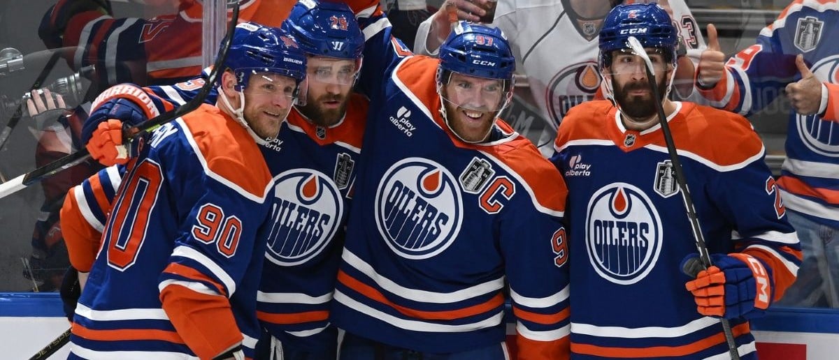 Connor McDavid celebrating on the ice after a goal – symbol of leadership and teamwork.